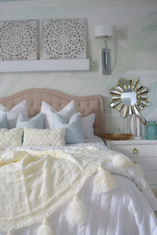 Tufted Camelback Headboard with Chunky Knit Throw and Sunburst Mirror