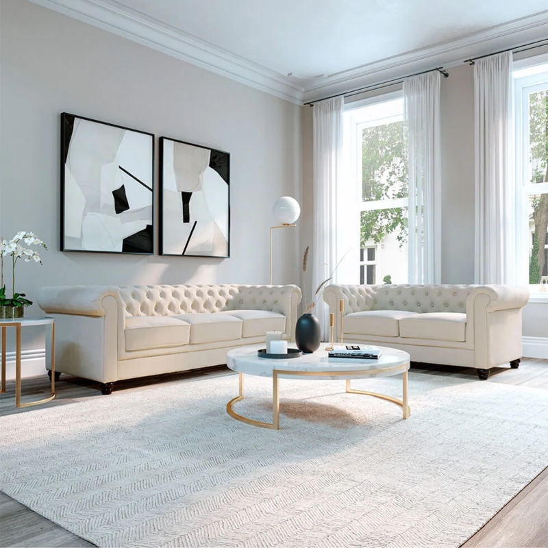 Tufted Chesterfield Sofas with Gold Accents and Abstract Art