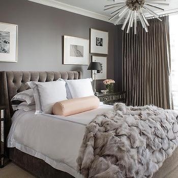 Tufted Platform Bed with Faux Fur Throw and Pink Bolster Pillow
