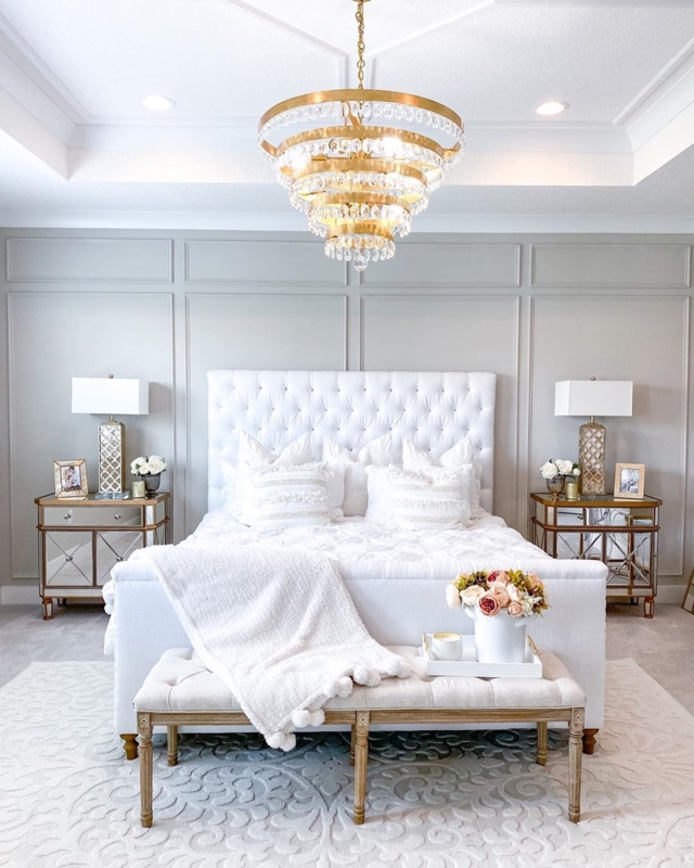 Tufted Upholstered Bed: Tiered Gold Chandelier & Pom Pom Throw