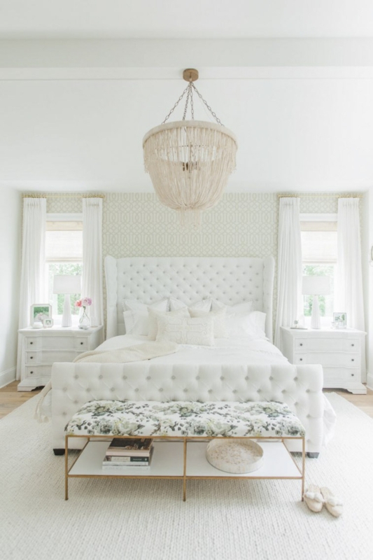 Tufted Wingback Bed with Tassel Chandelier and Floral Accent Bench
