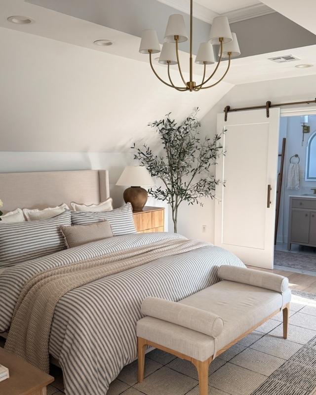 Upholstered Bed and Bench with Bolster Arms in Striped Bedding
