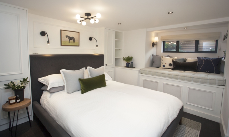 Upholstered Bed and Built-In Window Seat in Charcoal Grey Basement