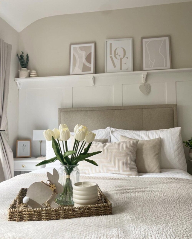 Upholstered Bed beneath Picture Ledge and Wainscoting Wall