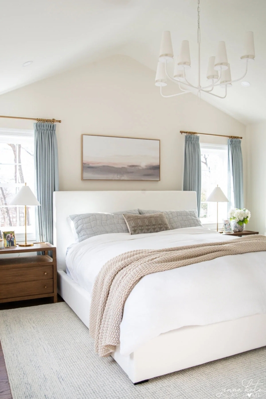 Upholstered Bed Frame with Light Blue Curtains and Vaulted Ceiling