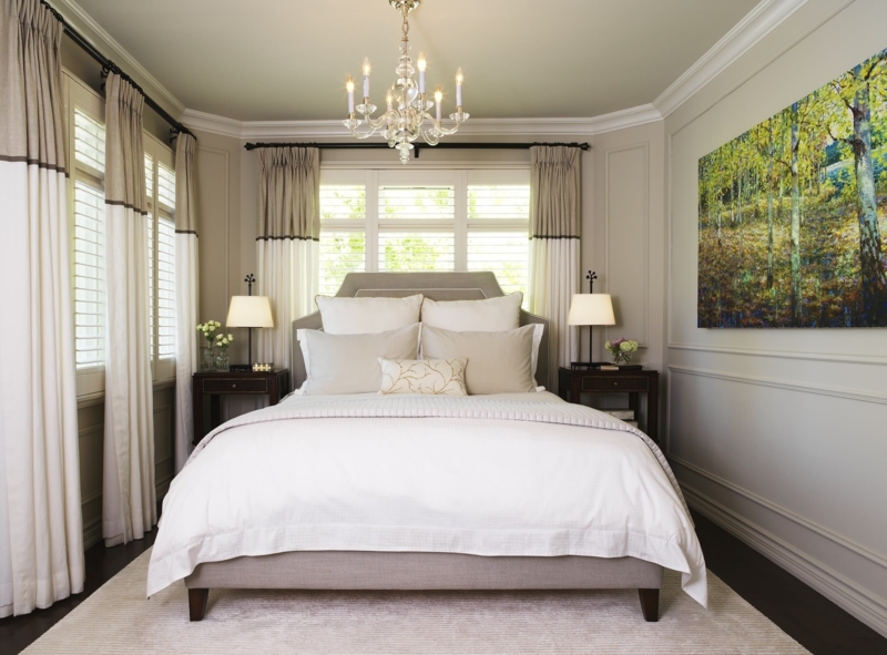 Upholstered Bed in Symmetrical Master Bedroom with Oversized Landscape Art