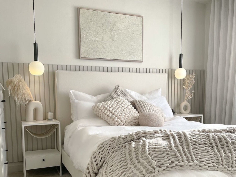 Upholstered Bed with Frosted Globe Pendants and Minimalist Slat Wall