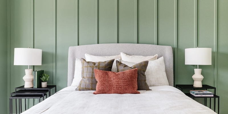 Upholstered Bed with Vertical Paneling and Terracotta Pillow