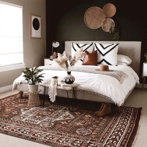 Upholstered Platform Bed against Dark Accent Wall with Terracotta Rug