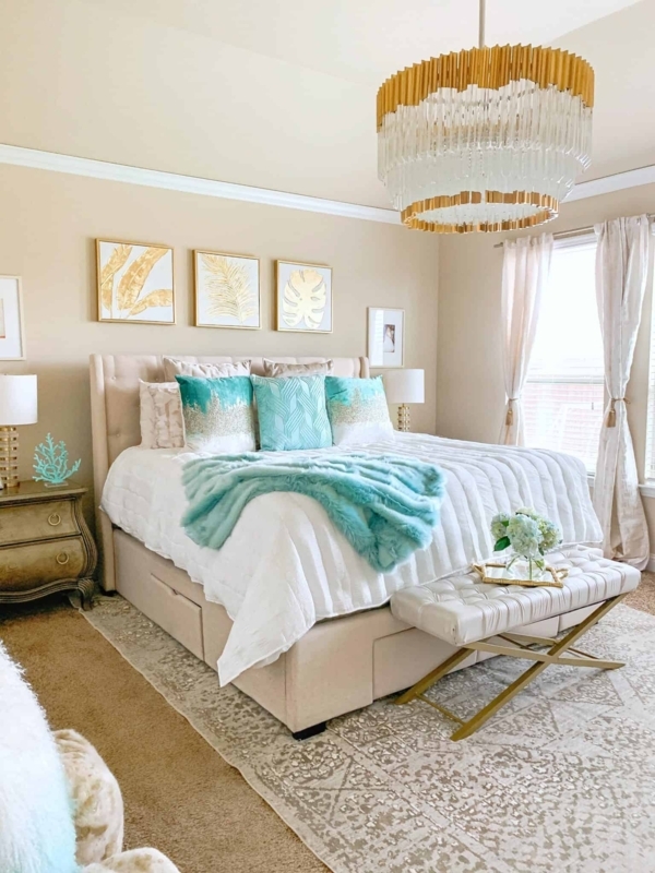 Upholstered Storage Bed with Tiered Glass Chandelier and Aqua Accents