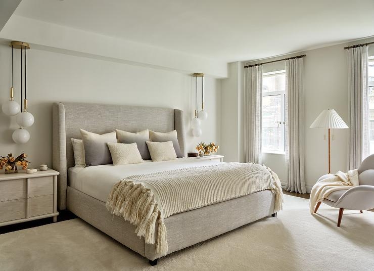 Upholstered Wingback Bed with Grey Ombre Pillows and Globe Pendants