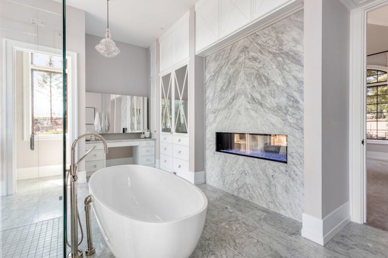 Upscale Master Bathroom with Fireplace and Book-Matched Marble Wall