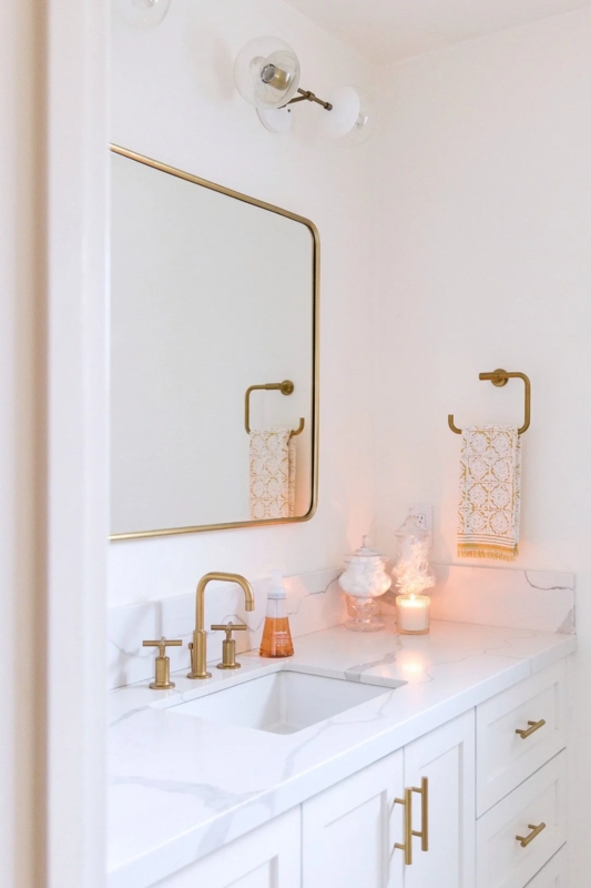 Vanity Area Gold Hardware, Thin Mirror. Brushed Gold Faucet.