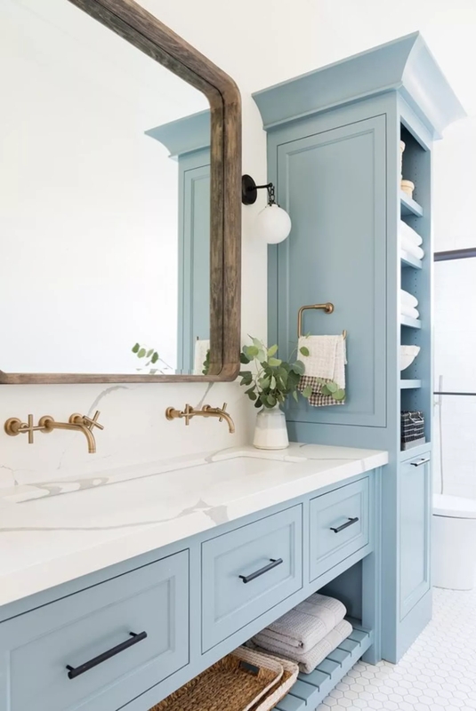 Vanity with Wall Mounted Brass Faucets, Marbled Top, and Linen Tower