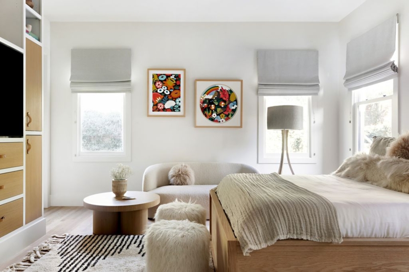 Vibrant Floral Wall Art in Neutral Bedroom with Striped Rug Accent