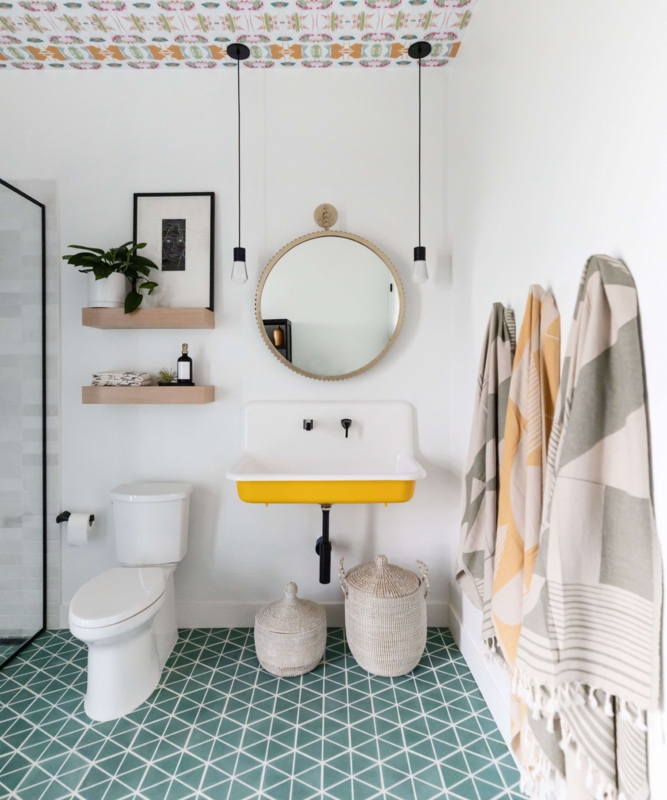 Vibrant Yellow Floating Sink Design with Green Geometric Floor Tiles