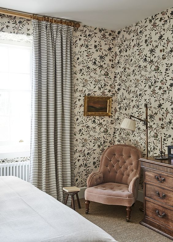 Vintage Accent Chair with Tufted Blush Upholstery and Floral Wallpaper