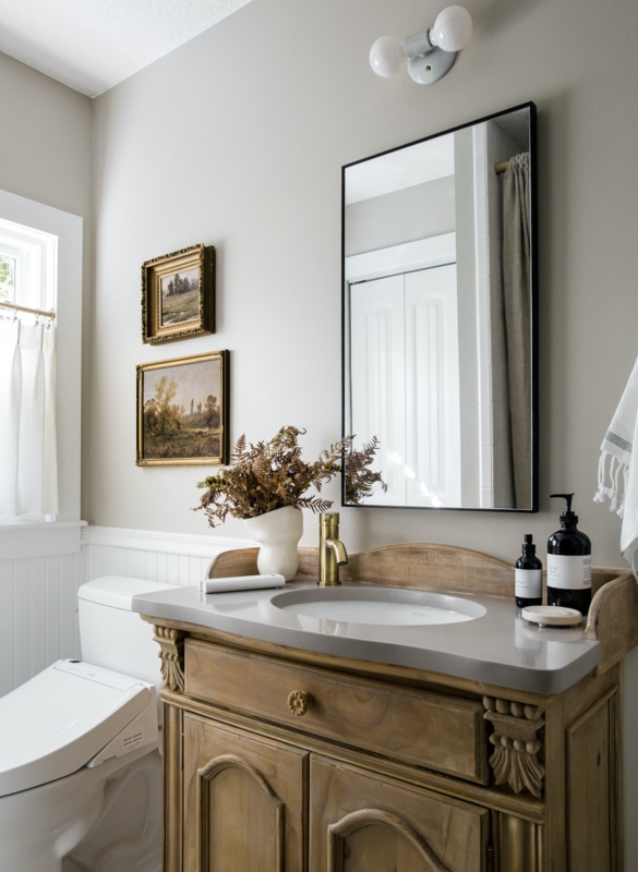 Vintage Style Carved Wood Vanity with Brass Faucet and Wainscoting