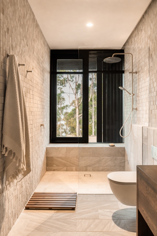 Walk-In Shower with Floor-to-Ceiling Window & Mosaic Wall in Modern Bath