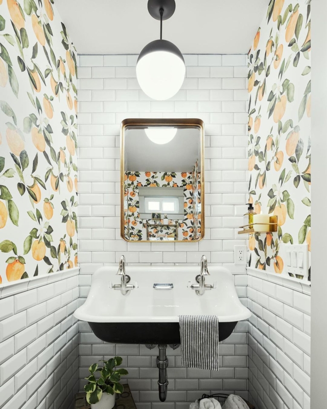 Wall Mount Sink Featuring Double Faucets and Vibrant Citrus Wallpaper