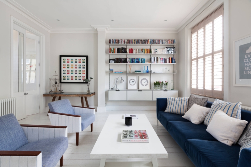 Wall Mounted Shelving with Navy Blue Sofa for a Coastal Blue Living Room