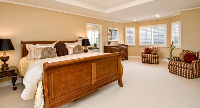 Warm Beige Master Bedroom with Plaid Seating Area