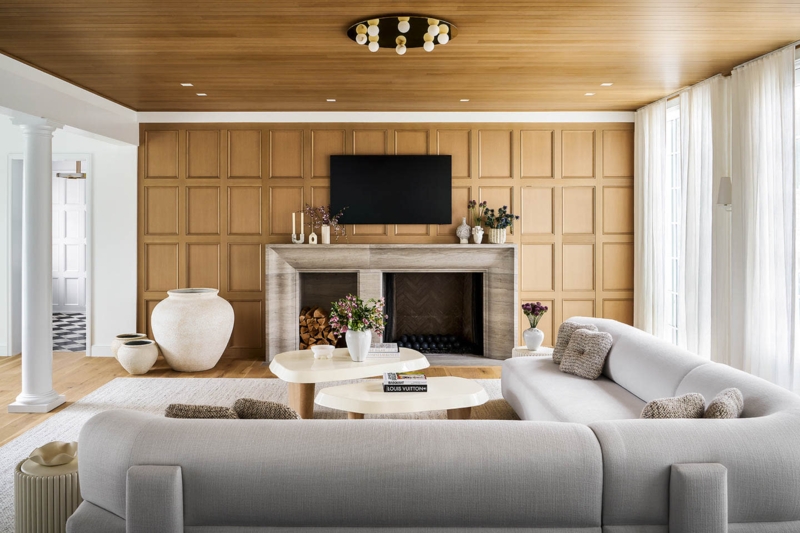 Warm Grid Wood Wall Paneling with Curved Sectional and Tables