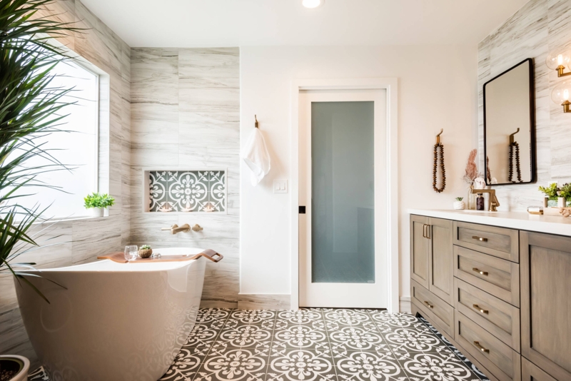 Warm Master Bathroom Design: Geometric Floor Tile & Brass Hardware
