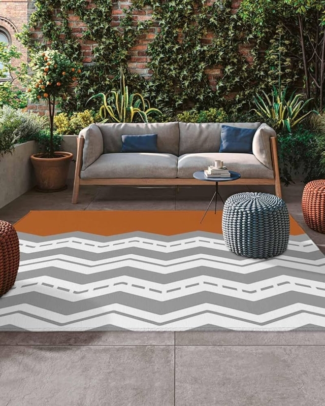 Wavy Orange Chevron Outdoor Area Rug for Modern Bohemian Deck.