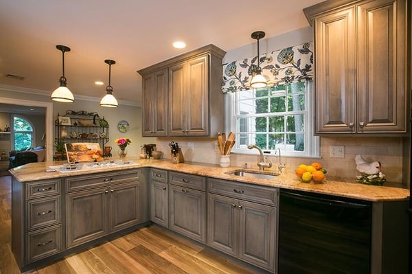 Weathered Wood Kitchen Cabinetry with Floral Window Treatment