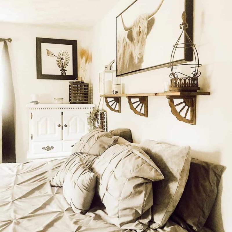 Western Farmhouse Bedroom Ideas: Wagon Wheel Shelf and Highland Cow Art