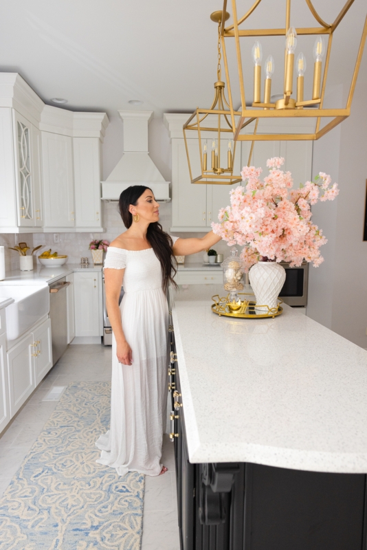 White and Gold Kitchen with Black Island and Lantern Pendants