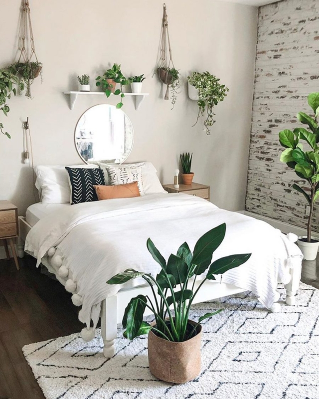 White Bed with Pom Pom Bedspread & Distressed Brick Wall