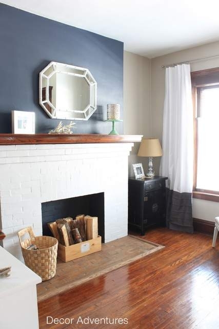 White Brick Fireplace Styling: Navy Wall Backdrop and Octagonal Mirror