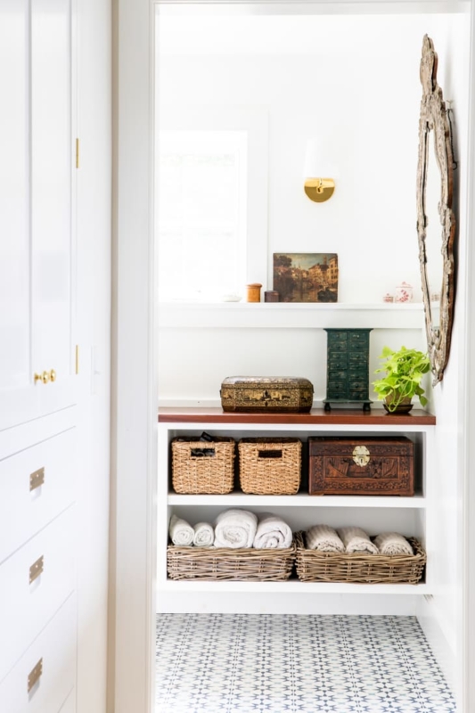 White Built-in Shelving Bathroom Nook with Baskets and Wood Countertop