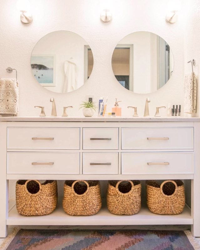 White Double Vanity with Baskets on Open Bottom Shelf and Round Mirrors