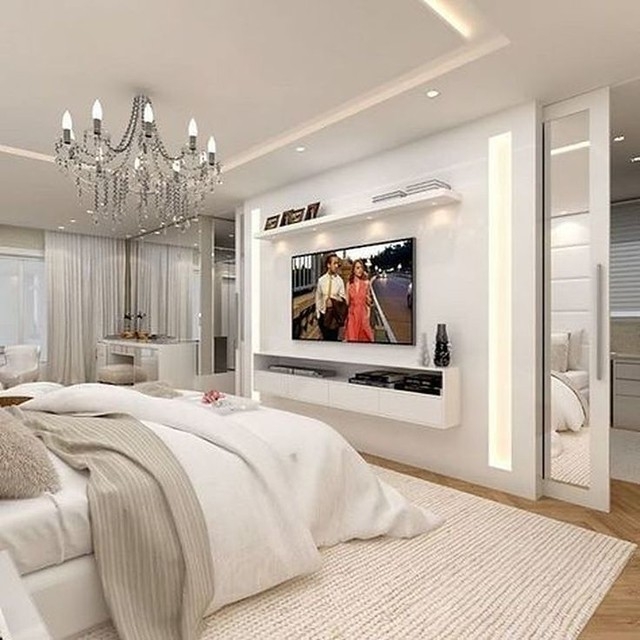 White Floating TV Stand with Crystal Chandelier and Recessed Lighting