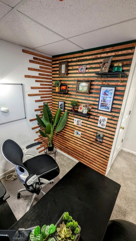 White-Framed Ergonomic Office Chair against Horizontal Wood Slat Wall