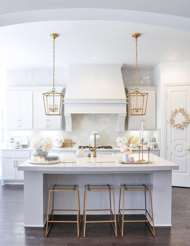 White Kitchen with Acrylic and Gold Bar Stools and Lantern Pendants
