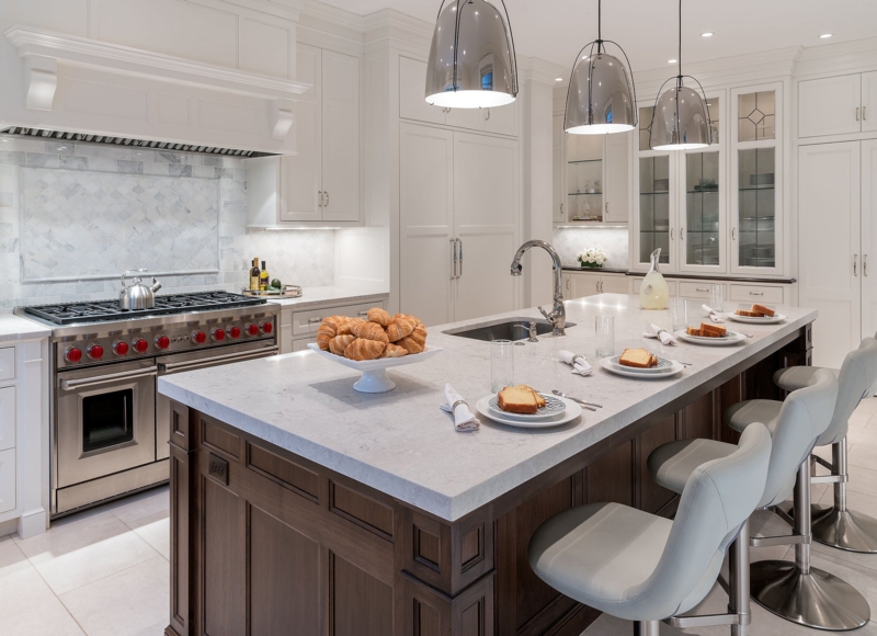 White Kitchen with Dark Wood Island and Elegant Silver Pendant Lighting