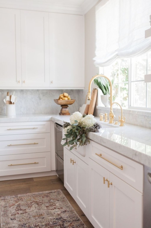White Kitchen with Gold Bridge Faucet and Farmhouse Sink