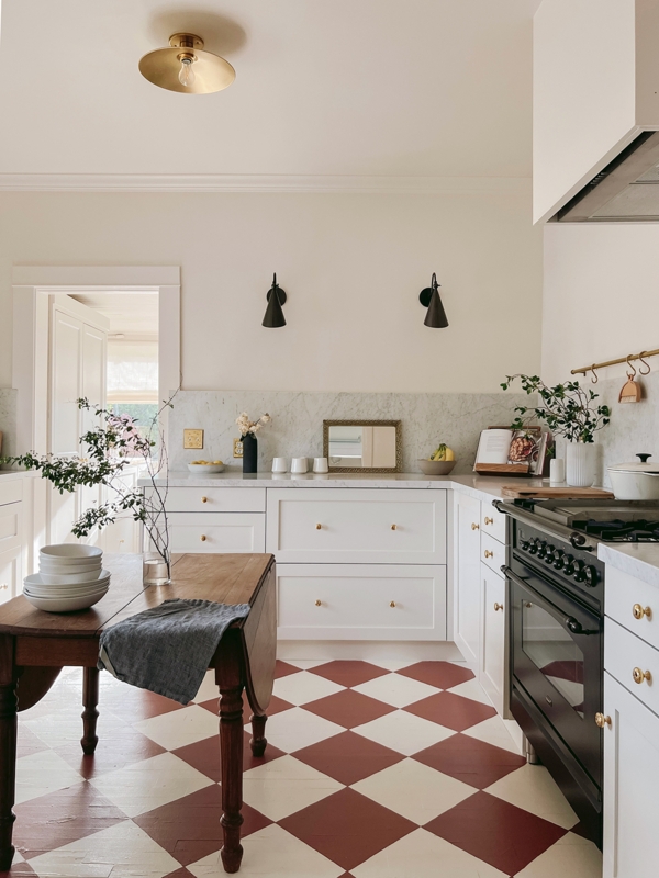 White Kitchen with Marble Backsplash and Checkerboard Floor