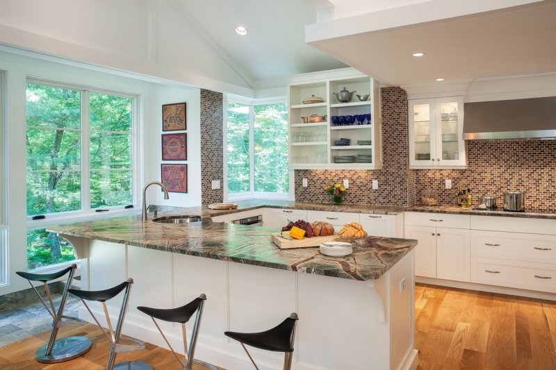 White Kitchen with Mosaic Tile Backsplash and U-Shaped Island.
