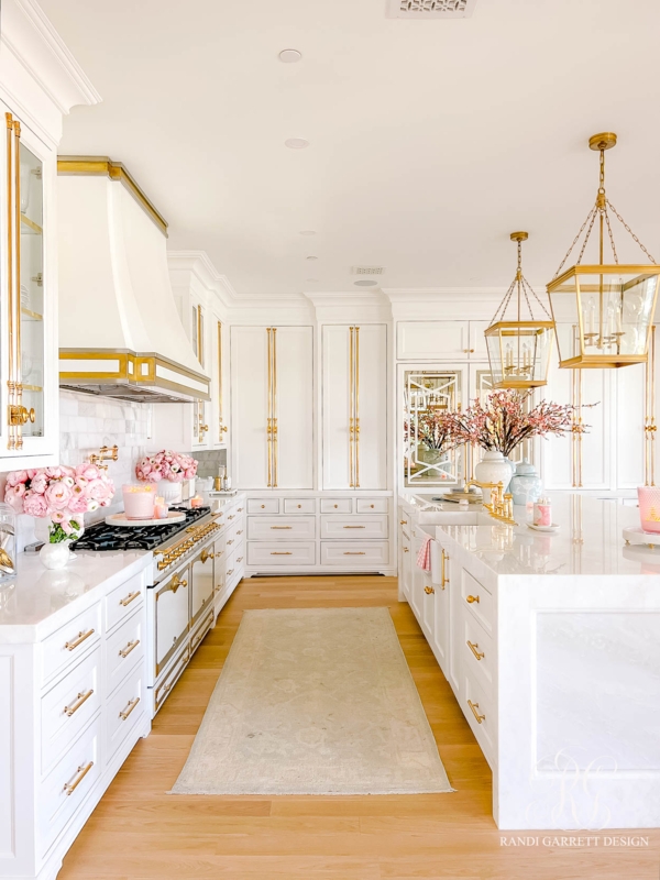 White Kitchen with Oversized Gold Hardware and Marble Island