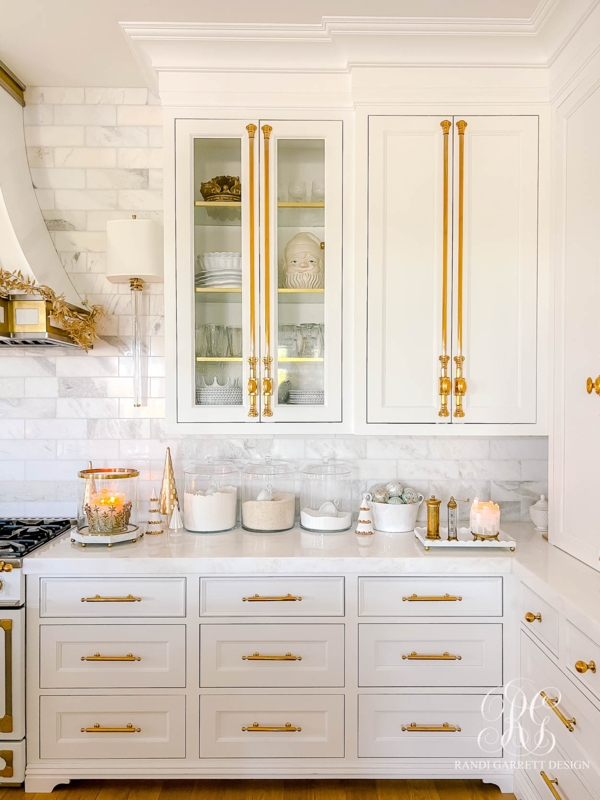 White Kitchen with Oversized Gold Hardware and Marble Subway Tile