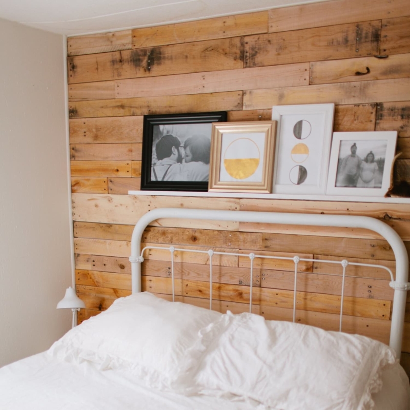 White Metal Spindle Bed Frame against Wood Plank Accent Wall
