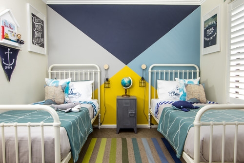 White Metal Twin Beds framing Geometric Accent Wall for Kids