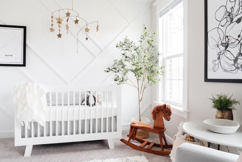 White Slatted Crib in Modern Scandinavian Nursery with Geometric Wall