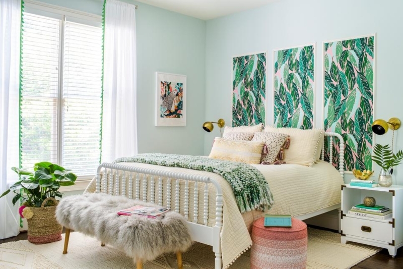 White Spindle Bed and Leaf Print Wall Panels in a Coastal Boho Bedroom