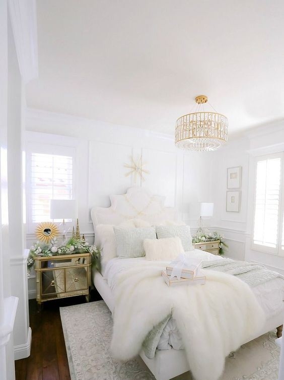 White Tufted Headboard Bed with Gold Tiered Chandelier and Faux Fur